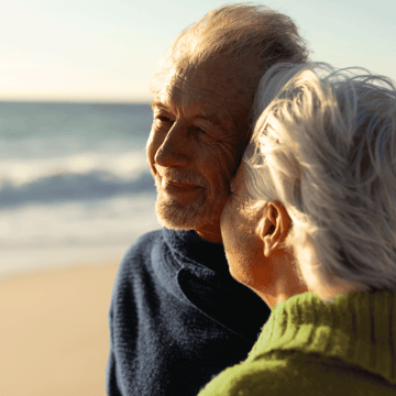 Florida couple walking along the beach at sunrise