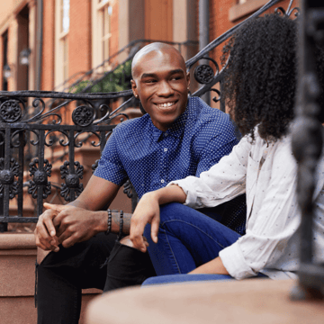 XYPN Couple talking on the steps of a brownstone